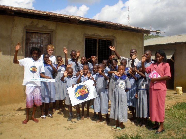 School children with BASIK sign waving